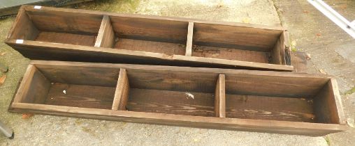 Two wooden three sectional feeding troughs.