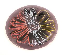 After Andy Warhol. Floral decoration glass plaque, printed signature, 34cm diameter.