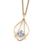 A modernist 9ct gold and pale blue gem set pendant, possibly a topaz, on a belcher link neck chain,