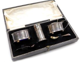 An Edward VIII silver three piece cruet set, with spoons and blue glass liners, boxed, Birmingham 19