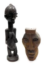 An African carved hardwood fertility figure, of a standing women, with a distended belly, 53cm high,