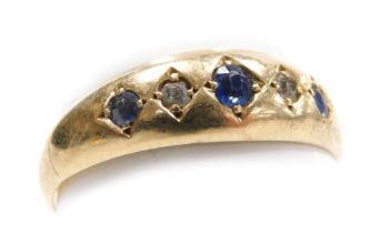 An 18ct gold sapphire and diamond five stone ring, in a rub over setting, size L, 1.9g.