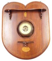 An Edwardian mahogany and inlaid shield shaped hall mirror, with two shaped shelves and brass hangin