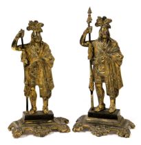 A pair of late 19thC brass doorsteps, modelled as native American Indians, 28cm high.