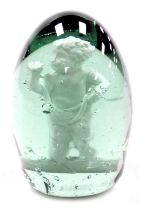 A 19thC green glass dump paperweight, internally decorated with a standing putto, 9cm high.