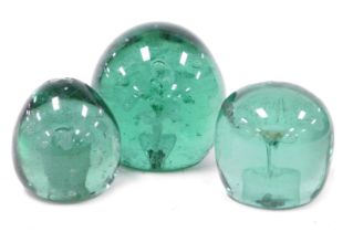 Three 19thC green glass dump paperweights, each decorated with flowers and a vase, one with four flo