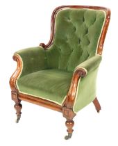 A Victorian mahogany armchair, upholstered in button back green draylon, raised on turned legs, bras