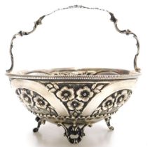 A Greek silver circular basket, embossed with flowers, raised on four scroll feet, stamped 925, EPT.