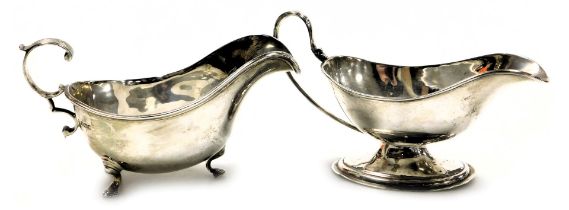 A George V silver sauce boat, with a scroll handle, raised on three hoof feet, Sheffield 1913, 6.65