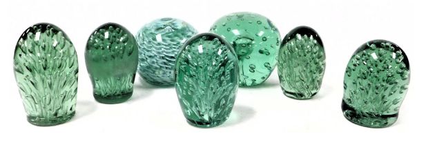 A group of 19thC green glass dump paperweight, each with profuse air bubble inclusions, together wit