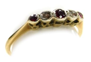 An 18ct gold ruby diamond five stone ring, in a high claw illusion setting, size N½, 1.9g.