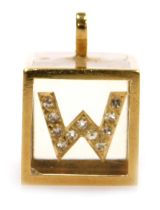 A 18ct gold and diamond set cube "W" pendant, 6.9g all in.