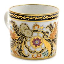 An early 19thC porcelain coffee can, polychrome decorated and gilded with flowers and scrolling leav