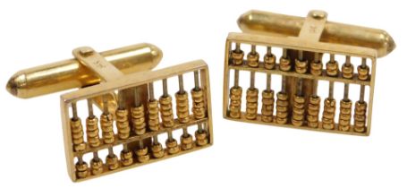 A pair of rectangular cuff links formed as abacuses, in yellow metal, stamped 14K, 5.9g.
