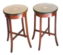 A pair of Edwardian mahogany circular side tables, with paterae inlay, raised on outswept legs, unit
