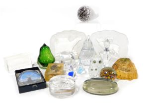 A group of glass paperweights and ornaments, including intaglio sculptures of a polar bear, and a mo