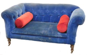 A Victorian mahogany two seater sofa, upholstered in blue button back draylon, raised on turned legs