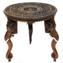 An early 20thC Anglo Indian hardwood occasional table, the circular top carved with the Hindu god Kr