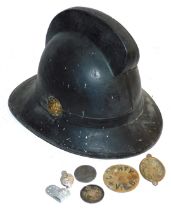 A black pith type fireman's helmet, two collar badges and medallions, a tag, etc.