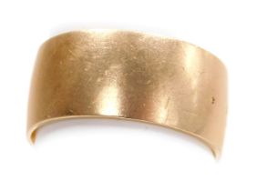 A wide wedding band, of plain form, yellow metal, bears marks, size R½, 8.4g.