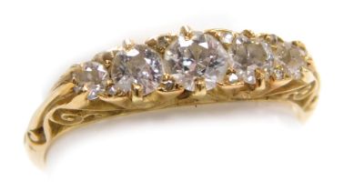 An Edwardian 18ct gold and diamond five stone ring, set with five diamonds graduated to the centre,
