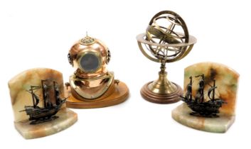 A replica brass and copper diver's helmet on an oak stand, 23.5cm wide, a French brass armillary sph