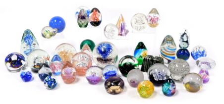 A group of late 20thC glass paperweights, various sizes and decoration, and a pair of New Zealand ja