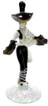 A Murano glass candlestick, of a figure in black and white striped trousers, stylised hat and puffed