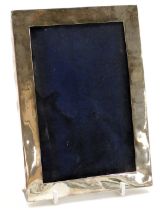 An Edward VII silver strut photograph frame, of plain rectangular form, London 1908, aperture 17cm x