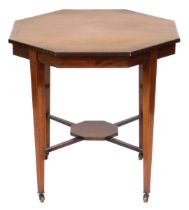 An Edwardian mahogany and satinwood crossbanded window table, with an octagonal top, raised on taper