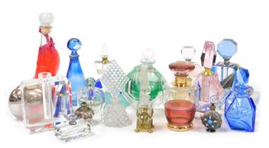 A group of cut glass scent bottles and stoppers, decanters and atomisers, together with a glass liqu