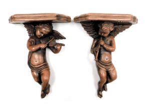 A pair of plaster wall shelves, modelled as cherubs playing musical instruments, 33cm high.