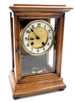 A late 19thC mahogany cased mantel clock, brass circular dial with enamel chapter ring bearing Arabi
