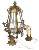 A Victorian brass framed hall lantern, with rose and chain suspension, the crown inset with bevelled