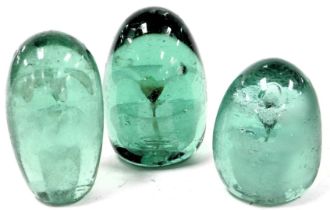 Three 19thC green glass dump paperweights, each decorated internally with flowers and a vase, two ha