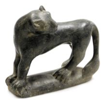 An Asian serpentine figure of a panther, carved in standing pose, with his head looking to the rear,