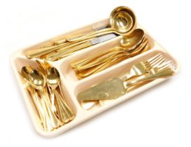 A group of German gold plated cutlery by SBS, including soup and cream ladles, cake slice, dessert a