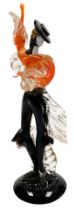 A Murano glass figure of a male Flamenco dancer, modelled standing, in orange and black, on a circul