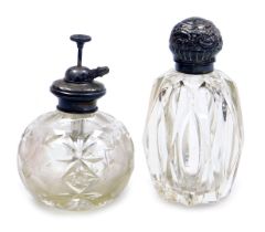 A Victorian cut glass scent bottle, with silver mount and hinged lid, embossed with rococo scrolls,