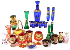 A group of Continental gilt overlaid coloured glassware, enamel decorated with flowers, including br