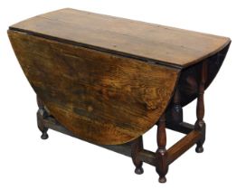 A 18thC and later oak gate leg dining table, raised on baluster turned supports united by a box stre