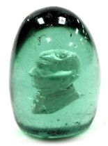 A 19thC green glass dump paperweight, internally decorated with a bust profile of William Ewart Glad