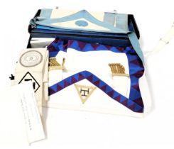A case of Masonic regalia, including aprons, sashes and gloves, books, jewels and certificates.