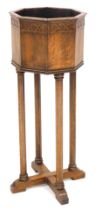 An early 20thC oak plant stand, of octagonal form, raised on octagonal columns, united by an X frame