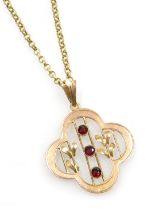 An Edwardian three stone garnet set floral pendant, in yellow and rose metal stamped 9ct, on a belch