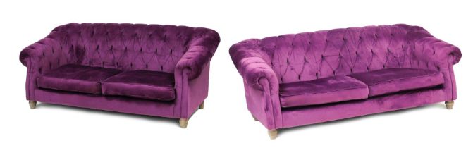 A pair of two seater button back sofas, upholstered in lilac velvet, with loose cushion seats, raise