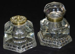 A Victorian hexagonal cut glass inkwell, with a brass mount and hinged vine embossed lid, 12cm wide,