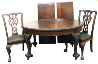 A Victorian mahogany wind out dining table, with two additional leaves, raised on leaf carved cabrio