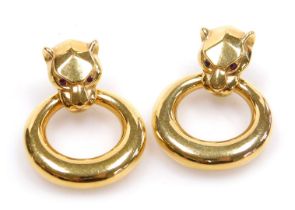 A pair of 18ct gold Cartier style panther's head and ring earrings, the head's set with rubies, 7.25