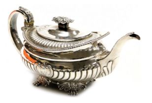 A George III silver teapot, of semi fluted form, with shell capped heart shaped reserve, monogram en
